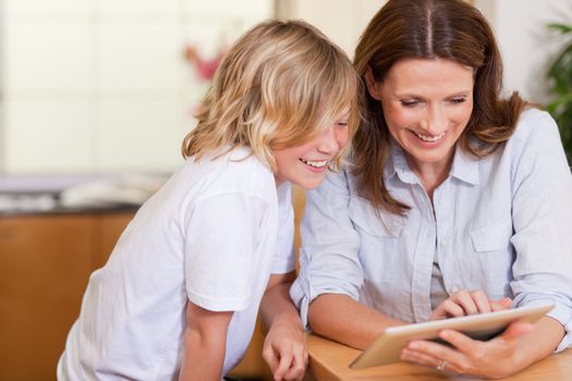 Mother and son using tablet together