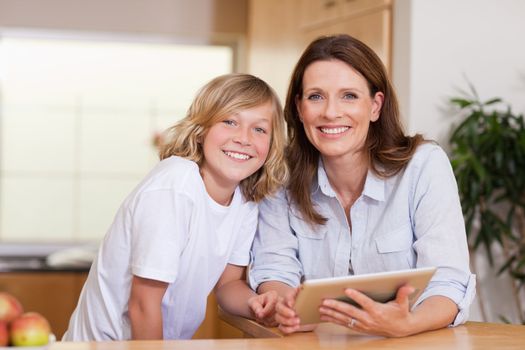 Woman and her son using tablet together