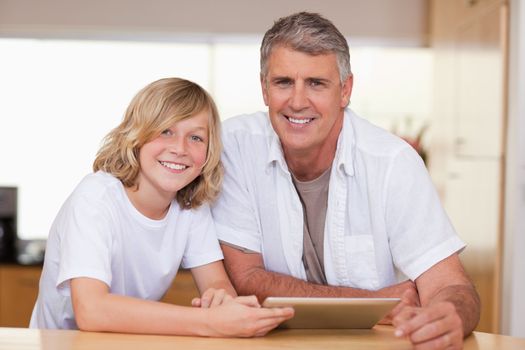 Boy and his father using tablet together