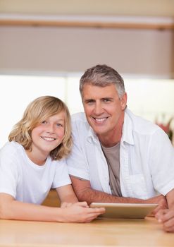 Man and his son using tablet together