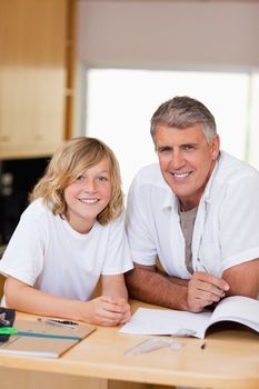 Father and son doing homework together