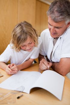 Man explaining homework to his son