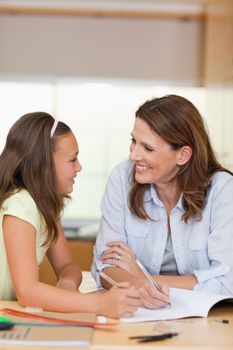 Woman doing homework together with her daughter