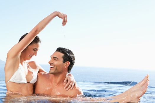 Happy couple enjoying their time together in the pool