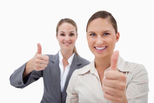 Sales persons posing with the thumb up against a white background