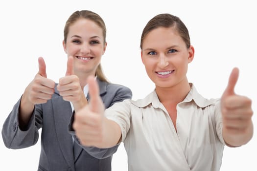Businesswomen posing with the thumb up against a white background