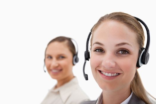 Young operators using headsets against a white background