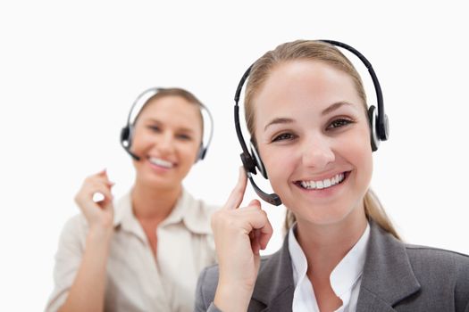 Joyful operators using headsets against a white background