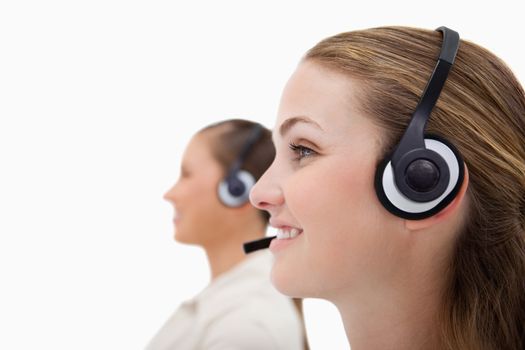 Side view of operators using headsets against a white background