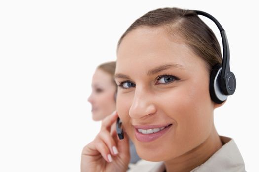 Young sales persons using headsets against a white background