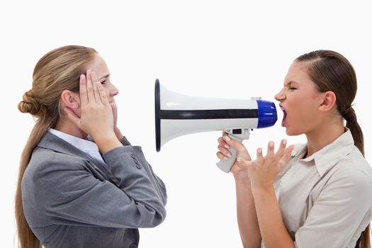 Manager yelling at her employee through a megaphone against a white background