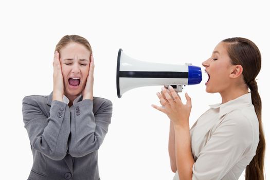 Manager yelling at her colleague through a megaphone against a white background