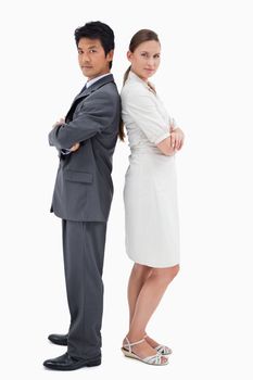 Portrait of business people standing back to back against a white background