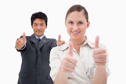 Business people with the thumbs up against a white background