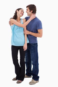 Portrait of a couple embracing each other against a white background