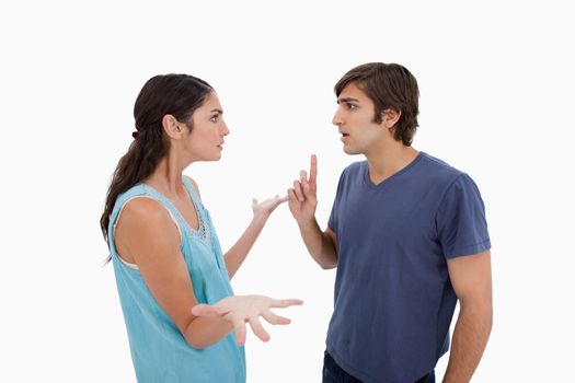Angry couple arguing against a white background