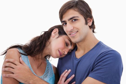 Couple embracing each other against a white background