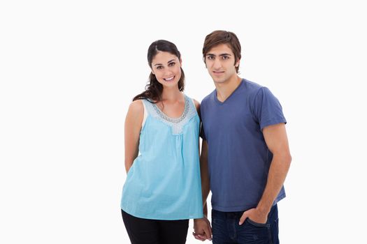 Couple holding hands against a white background
