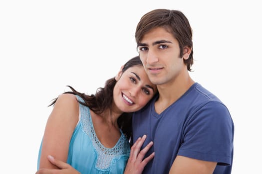 Charming couple embracing each other against a white background