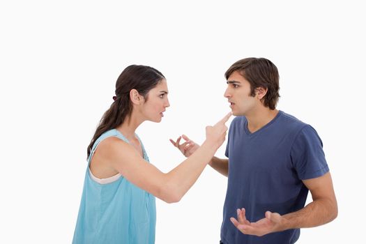 Young couple arguing against a white background