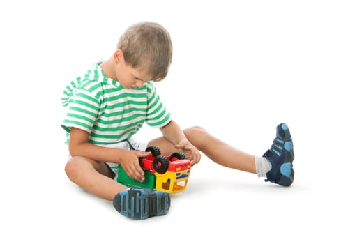 Boy holding a car isolated on white background