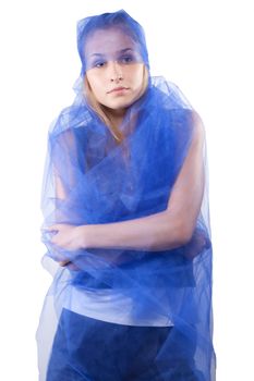 beautiful woman wrapped in blue tulle studio shooting