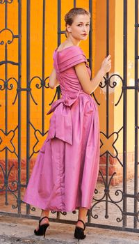 A girl in a bright dress near the shooting on outdoors grid