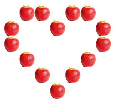 Red apples shaping a heart on white background