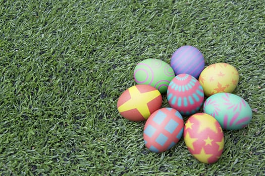 Colorful easter eggs on green field