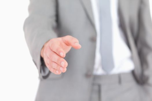 Masculine hand ready for a handshake against a white background