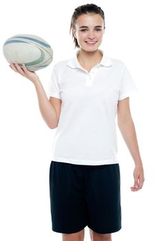 Lovely isolated caucasian teenager with a football over white background