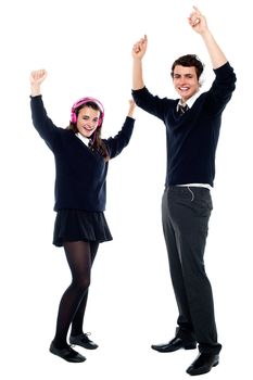 School going teenagers using headphones and dancing to the beat isolated on white background