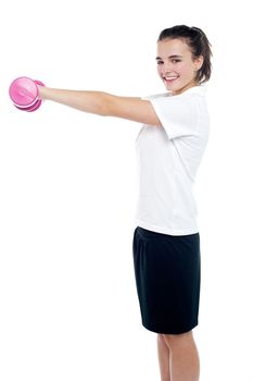 Happy fitness girl lifting dumbbells smiling cheerfully
