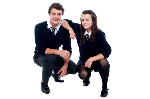 Girl resting hand on her friends shoulder, semi seated posture