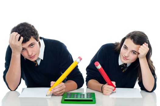 Confused students holding their heads during examination. Trying to recollect the answer