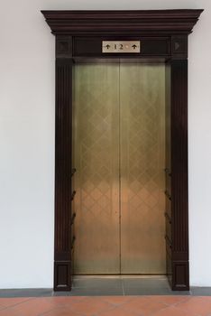 Old vintage lift with three levels on white wall