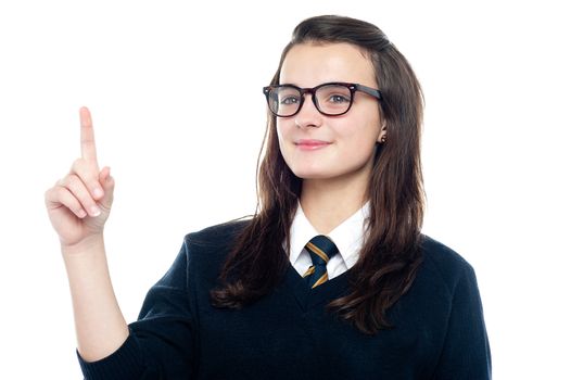Smart girl raises her finger to draw the attention of class teacher