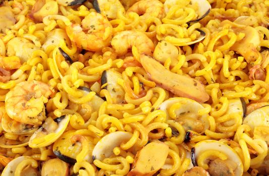 detail of typical Spanish food noodles with prawns clams squid and prawns