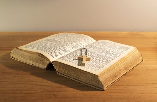 old bible book with wooden cross