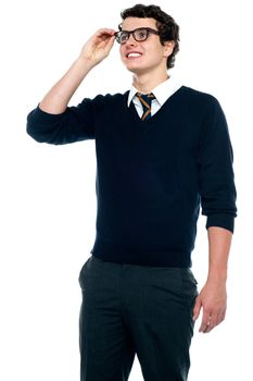An innocent schoolboy adjusting his eyeglasses to make his vision clear