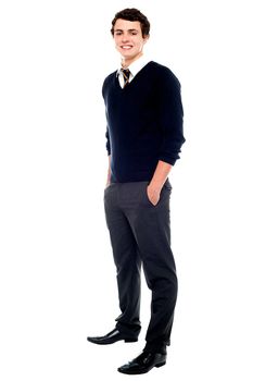 Full length portrait of a school going youngster with hands in pocket posing casually