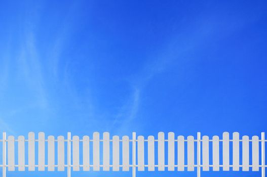 white fence and blue sky