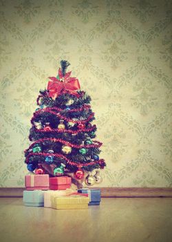 Vintage image, Christmas tree with gifts on decorative wallpaper