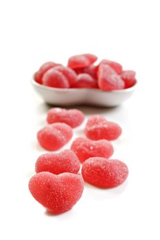 Red heart shaped sweets on a pure white background