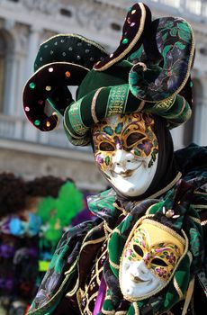 Elegant green and purple jester , dressed with ivy shaped velvet dress. Venice carnival 2012