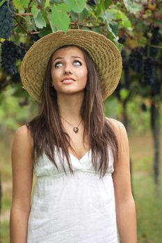 Worried and funny expression of a beautiful girl in a grapevine
