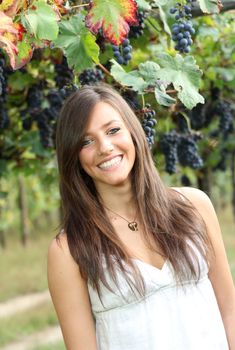 Happy and beautiful  girl with big smile in a autumn vineyard 