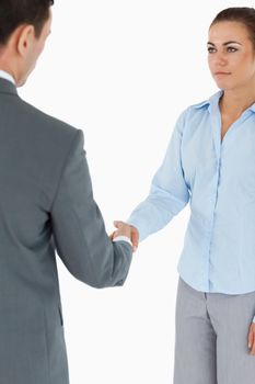 Young business partners doing a deal against a white background