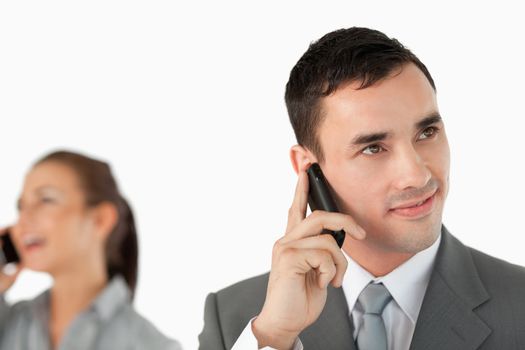 Close up of business partners talking on the cellphone against a white background