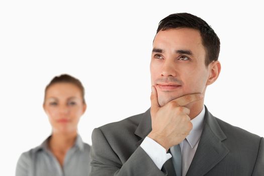 Close up of thinking businessman with colleague behind him against a white background